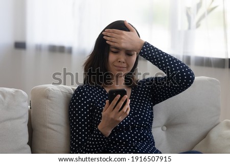 Stressed upset young asian woman slap forehead read telephone reminder message forget to make loan payment in time. Sad confused vietnamese lady hold cell seeing problem missed important call meeting Royalty-Free Stock Photo #1916507915