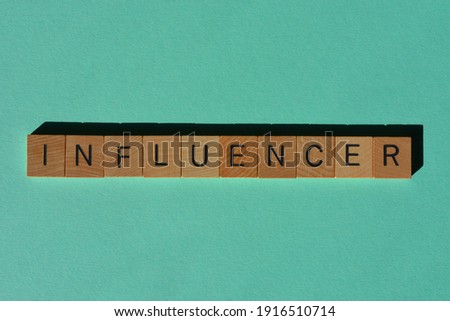 Influencer, word in wooden alphabet letters isolated on plain background as a banner headline
