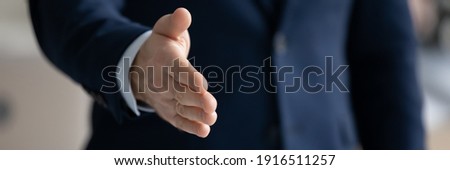 Banner panoramic header view of businessman stretch hand for handshake greet get acquainted at meeting in office. Male CEO shake hand welcome newcomer at workplace. Acquaintance concept. Royalty-Free Stock Photo #1916511257