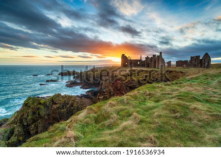 Dramatic sunset over the eerie ruins Slains Castle near Peterhead on the east coast of Scotland