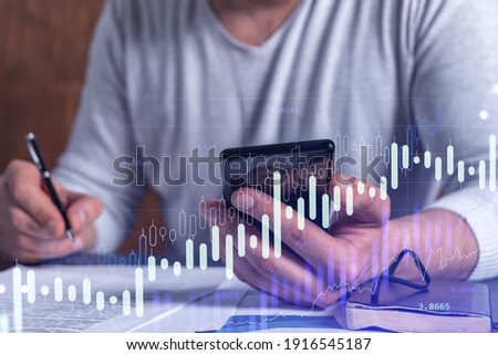 A client in casual wear is signing the contract to invest money in stock market. Internet trading and wealth management concept. Checking the details of transaction at smart phone. Royalty-Free Stock Photo #1916545187