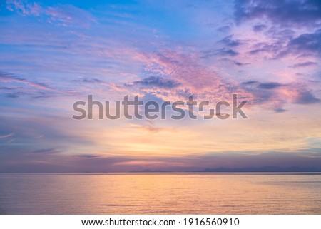 The ocean and vanilla sky at a private beach in Trat, Thailand. Royalty-Free Stock Photo #1916560910