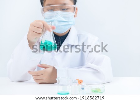 Young Scientists shaking blue liquid chemical in Erlenmeyer flask isolated on white background. Science laboratory and Education concept.