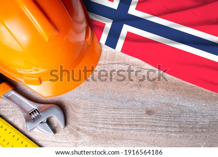 Norway flag with different construction tools on wood background, with copy space for text. Happy Labor day concept.