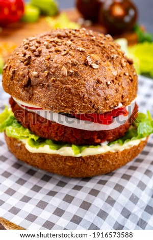 Tasty hamburger made from vegetarian plant based imitation minced meat burger and fresh vegetables