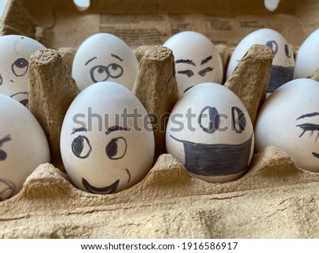 many white chicken eggs with funny faces lie in nest of straw on white background. painted eggs with emotions: with eyes and in mask, sad and surprise. preparation for Easter. creativity