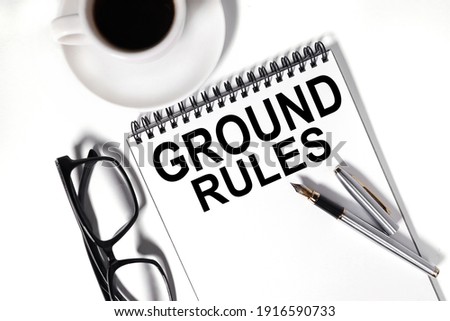 ground rules . text on white notepad paper on white background.