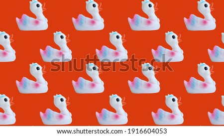 Duck seamless pattern isolated on red background. Place for your text. Seamless pattern of ducks on a pink background. Duck background texture.