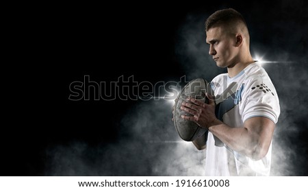 Man rugby player holds ball. Sports banner. Horizontal copy space background