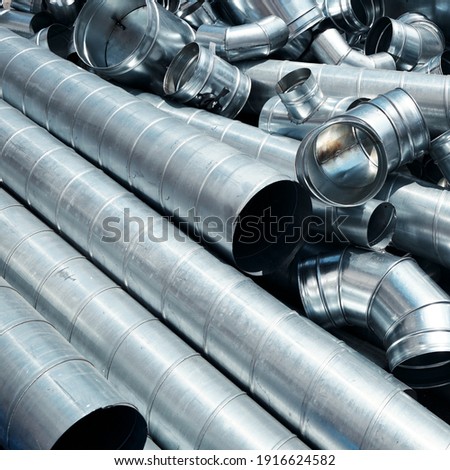 Pile of pipes and parts for duct systems. Industrial ventilation