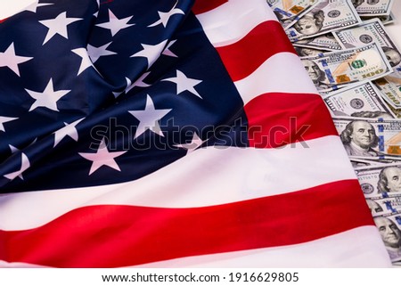 United States of America waving flag with many folds 100 dollar bills  ,joe biden 2021 Royalty-Free Stock Photo #1916629805
