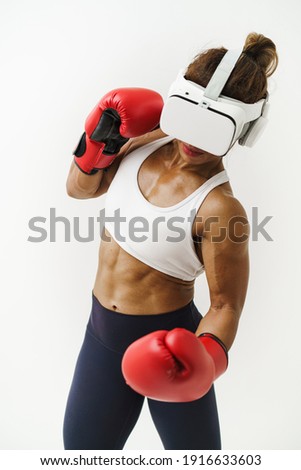 Vertical shot of Asian woman wearing VR headset to exercise with simulation boxing games, Young female athlete boxer with virtual reality combat experience activity. 