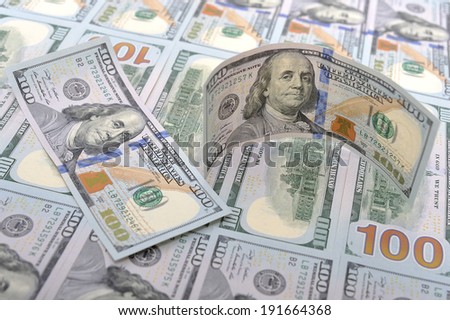 New banknotes on a background of hundred dollars