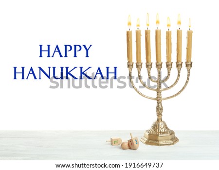Happy Hanukkah. Traditional menorah and dreidels on wooden table