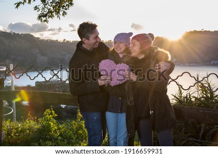 Family having a good time by the view of the Lake Averno with the temple of Apollo background , in Pozzuoli Italy