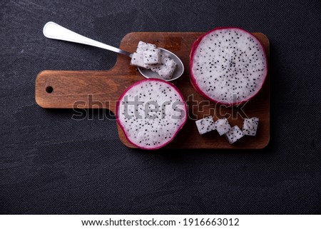 Dragon fruits cut out and exposed on dark backgrounds