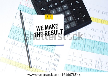text, calculator and pen are on a sticker on desktop. calculator and pen. Business concept.