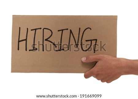 Hand holding up a hiring sign