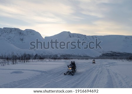 
snowmobiles in winter on a snowy road