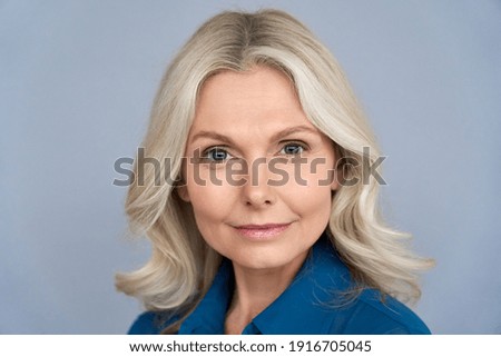 Confident middle aged blonde business woman looking at camera isolated on grey background. Successful proud older 50s lady professional coach, mentor, leader close up front face headshot portrait.