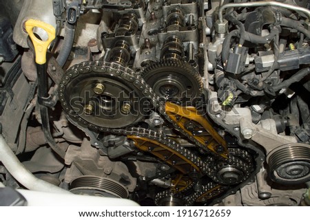 View of the chain camshaft drive of a diesel automobile internal combustion engine under the hood of the car