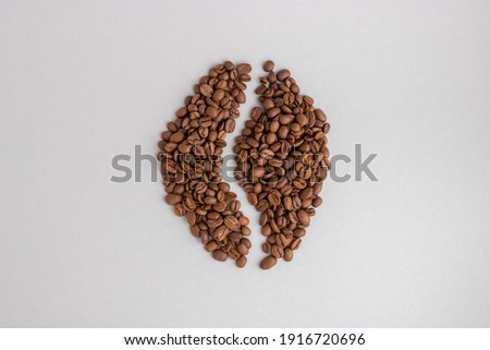 Coffee beans. Isolated on a gray background in the shape of a coffee bean.