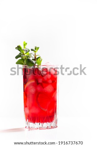 Refreshing red tea with ice, mint and lemon on white background, close-up, copy space, vertical orientation 