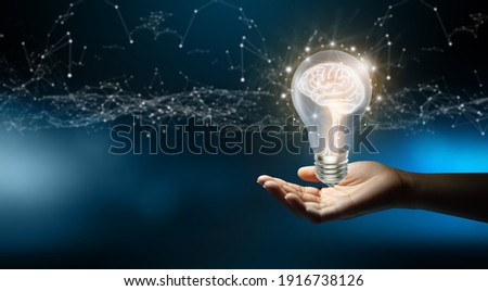 Businessman holding Light bulbs with Brain inside and Low poly wireframe outside. Creative and innovation inspiration. Business Bright idea concept. Royalty-Free Stock Photo #1916738126