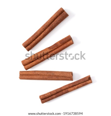 Cinnamon sticks isolated over white background closeup. Canella spice. Aromatic condiment background. Flat lay, top view. Royalty-Free Stock Photo #1916738594