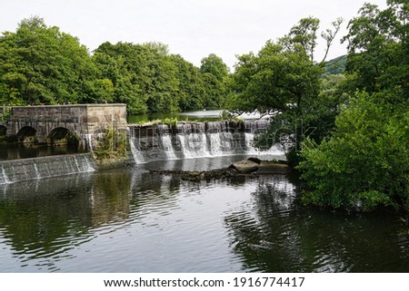 A weir on the River Derwent at Belper in Derbyshire Royalty-Free Stock Photo #1916774417