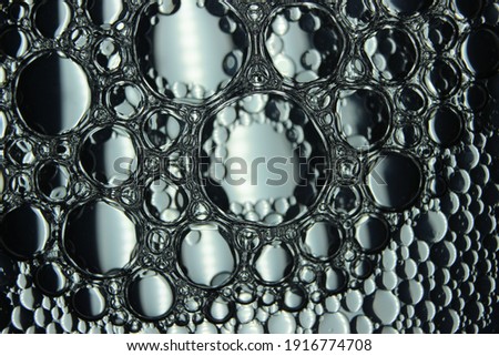 Macro close-up view of bubbles on water. Oil bubbles in the water macro photographic background