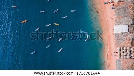 Aerial view of the sea full of boats and the shore of the beach copn tourists in a bay of Acapulco in Mexico