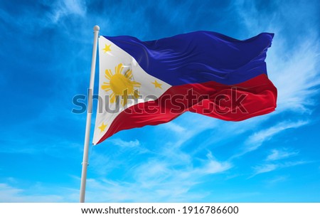 Large Philippines flag waving in the wind Royalty-Free Stock Photo #1916786600
