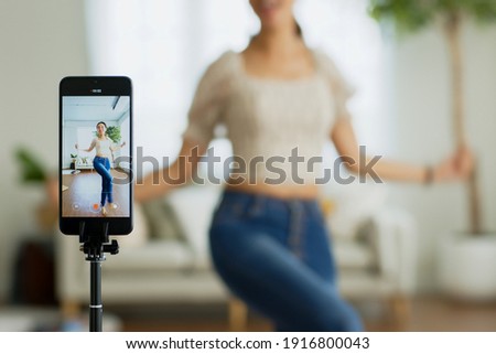 Asian young woman created her dancing video by smartphone camera. To share video to social media application. Royalty-Free Stock Photo #1916800043