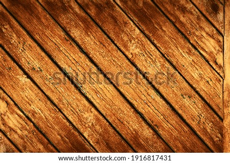 Faded orange paint, Vintage background with wooden planks stacked diagonally, textured surface, outdoor exposure horizontal photography close-up.