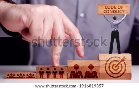 Business, Technology, Internet and network concept. Young businessman shows the word:Code of conduct 