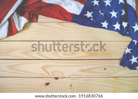 Close up of waving national usa american flag on wooden background with copy space for text.