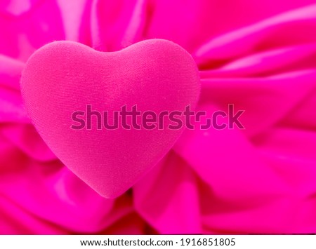 Pink cloth heart shape on abstract background blurred background. For Valentine's Day with a sweet and romantic moment.