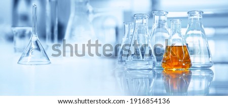 flask and glassware equipment in chemistry science laboratory blue banner background	 Royalty-Free Stock Photo #1916854136