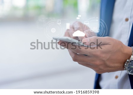 close up on businessman hand holding smartphone to synchronize on SaaS host server to working on system for technology and b2b business concept Royalty-Free Stock Photo #1916859398