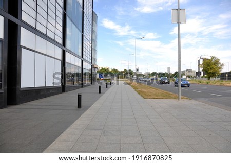 The sidewalk next to the shopping mall building Royalty-Free Stock Photo #1916870825
