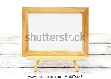 natural wooden picture frame on white wooden table   
