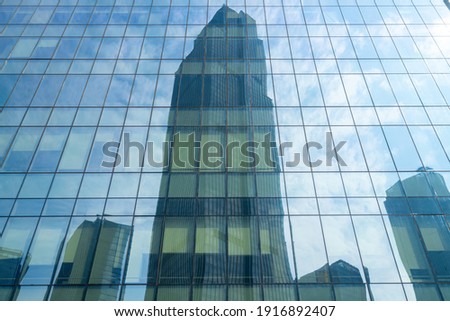 Looking Up Blue Modern Office Building Royalty-Free Stock Photo #1916892407