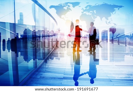 Silhouettes of Two Businessman Shaking Hands Royalty-Free Stock Photo #191691677