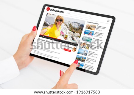 Woman watching videos online on tablet