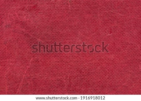 The texture of the old book cover is orange. Grunge background, worn vintage surface