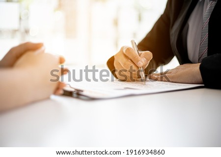 The HR department is reviewing the resumes of job applicants, resumes are important documents for job application. It should contain resume, training history, education, talent, work skills, etc. Royalty-Free Stock Photo #1916934860