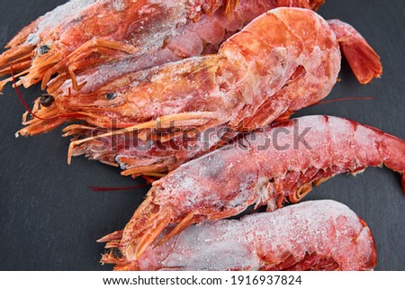 Fresh shrimps on dark background. Red raw prawns.Frozen seafood