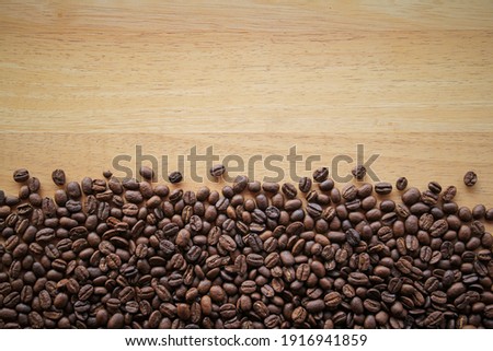 Coffee beans on wood background 