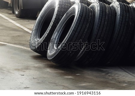 Piles of new tires in tyre warehouse in car garage. 